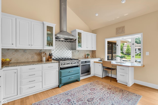 103 Gettysburg, Coatesville, IN 46121 - kitchen with oven, ventilation hood, light wood-style flooring, white cabinets, and tasteful backsplash