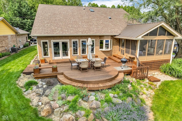103 Gettysburg, Coatesville, IN 46121 - back of house with a sunroom, a wooden deck, brick siding, a yard, and outdoor dining area