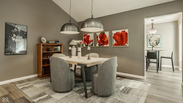 4428 Edinburgh Pt, Indianapolis, IN 46228 - dining room with light wood-style flooring, baseboards, and high vaulted ceiling