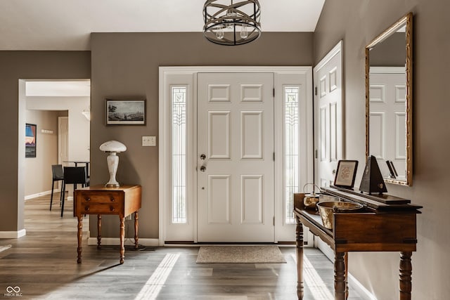 4428 Edinburgh Pt, Indianapolis, IN 46228 - entryway featuring baseboards, wood finished floors, and a chandelier