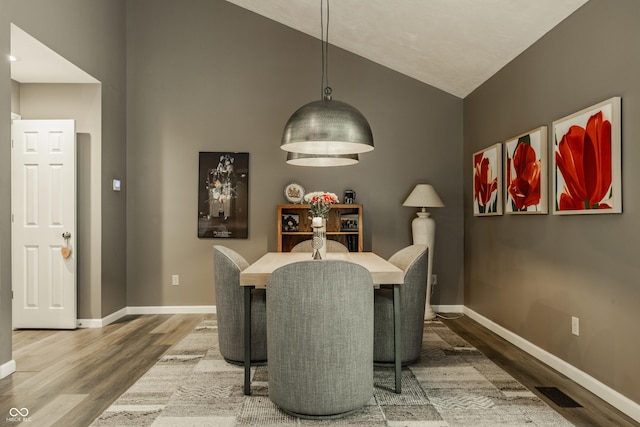 4428 Edinburgh Pt, Indianapolis, IN 46228 - dining room with wood finished floors, vaulted ceiling, and baseboards