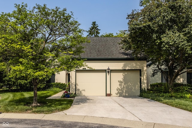 4428 Edinburgh Pt, Indianapolis, IN 46228 - view of property hidden behind natural elements featuring a garage, stucco siding, driveway, and a front yard