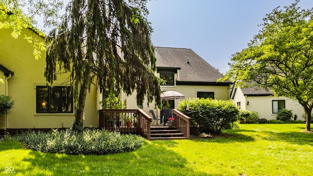 4428 Edinburgh Pt, Indianapolis, IN 46228 - back of house featuring a wooden deck, a yard, roof with shingles, and stucco siding