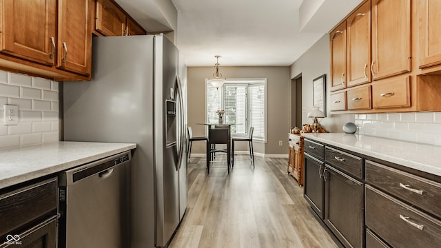 4428 Edinburgh Pt, Indianapolis, IN 46228 - kitchen with appliances with stainless steel finishes, tasteful backsplash, light countertops, and light wood-type flooring