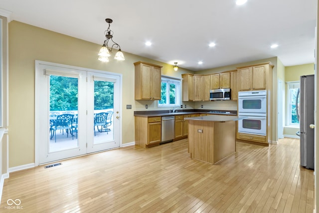11036 Ravenna Way, Indianapolis, IN 46236 - kitchen featuring appliances with stainless steel finishes, light wood-style flooring, a kitchen island, baseboards, and recessed lighting