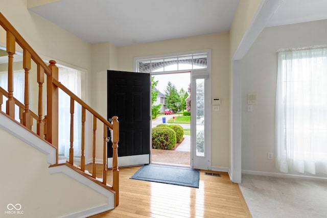 11036 Ravenna Way, Indianapolis, IN 46236 - entryway with plenty of natural light, stairs, and wood-type flooring