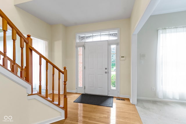 11036 Ravenna Way, Indianapolis, IN 46236 - entryway with stairs, baseboards, and wood finished floors