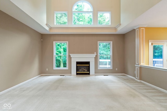 11036 Ravenna Way, Indianapolis, IN 46236 - unfurnished living room with carpet floors, a fireplace with flush hearth, baseboards, and a towering ceiling