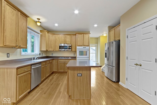 11036 Ravenna Way, Indianapolis, IN 46236 - kitchen with appliances with stainless steel finishes, light wood-type flooring, a kitchen island, a sink, and light brown cabinetry