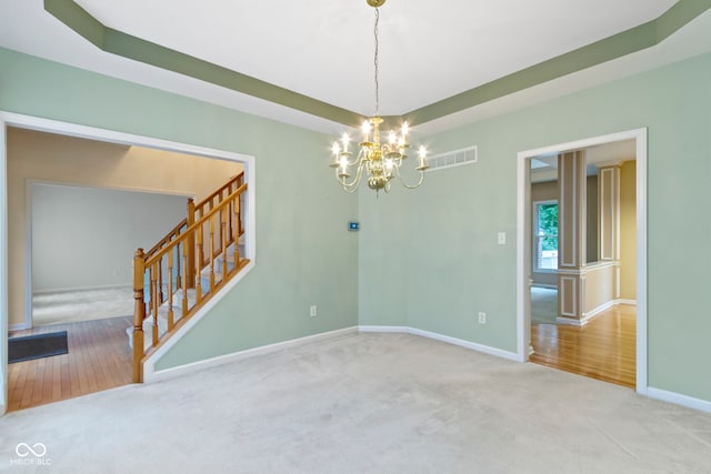 11036 Ravenna Way, Indianapolis, IN 46236 - carpeted spare room featuring a chandelier, stairs, baseboards, and a raised ceiling