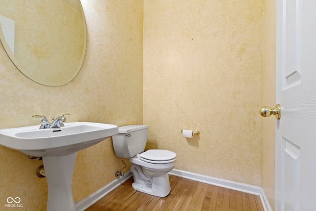 11036 Ravenna Way, Indianapolis, IN 46236 - half bathroom with wood-type flooring, toilet, and baseboards