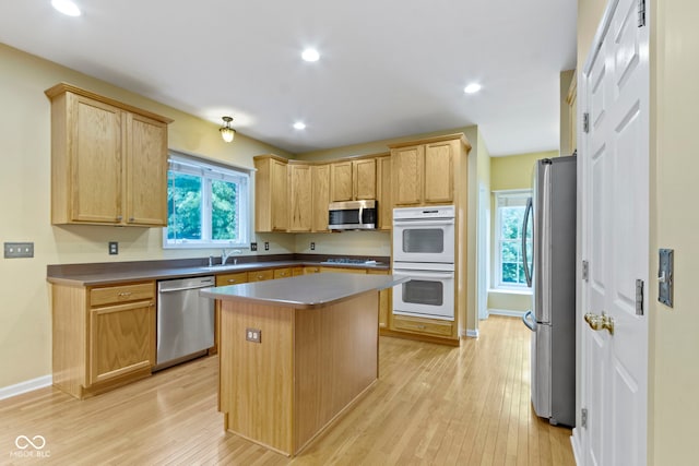 11036 Ravenna Way, Indianapolis, IN 46236 - kitchen featuring stainless steel appliances, light wood-style flooring, a kitchen island, recessed lighting, and light brown cabinetry