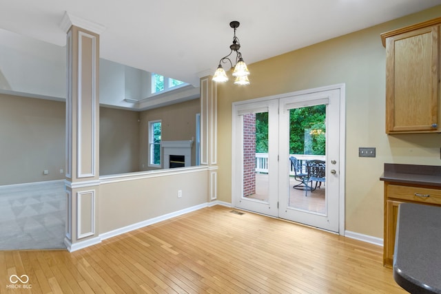 11036 Ravenna Way, Indianapolis, IN 46236 - unfurnished dining area with light wood-type flooring, baseboards, and a fireplace