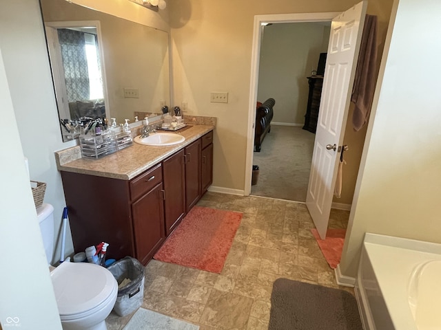 2253 Jaybird Dr, Greenfield, IN 46140 - bathroom with vanity, toilet, a bath, and baseboards