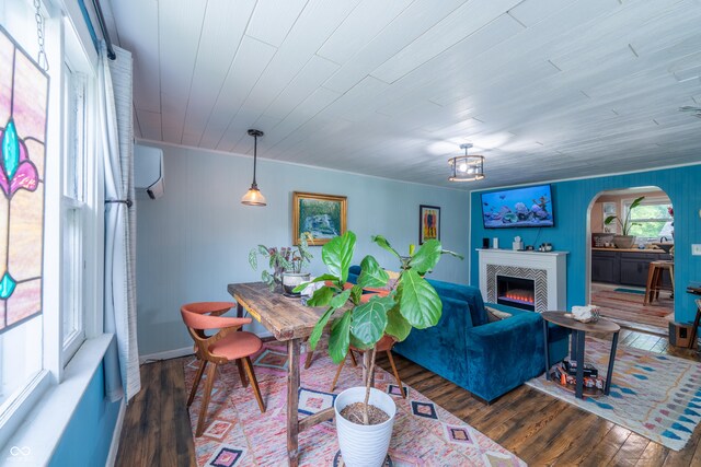 1101 S Rogers St, Bloomington, IN 47403 - living area featuring arched walkways, wood finished floors, a tile fireplace, and a wall mounted AC