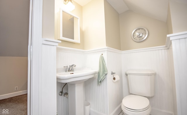 5024 N Kenwood Ave, Indianapolis, IN 46208 - half bath featuring wainscoting, toilet, vaulted ceiling, and a sink