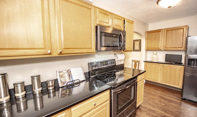 5024 N Kenwood Ave, Indianapolis, IN 46208 - kitchen with stainless steel appliances, dark countertops, light brown cabinets, a textured ceiling, and dark wood finished floors