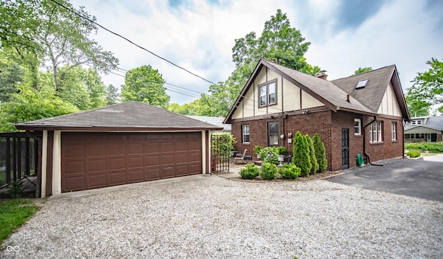 5024 N Kenwood Ave, Indianapolis, IN 46208 - view of property exterior featuring an outbuilding, a detached garage, brick siding, and a chimney
