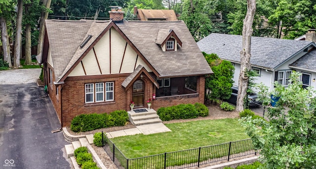 5024 N Kenwood Ave, Indianapolis, IN 46208 - english style home featuring brick siding, stucco siding, a chimney, and asphalt driveway