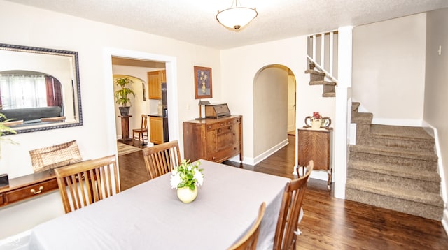 5024 N Kenwood Ave, Indianapolis, IN 46208 - dining room with arched walkways, wood finished floors, stairs, and a textured ceiling