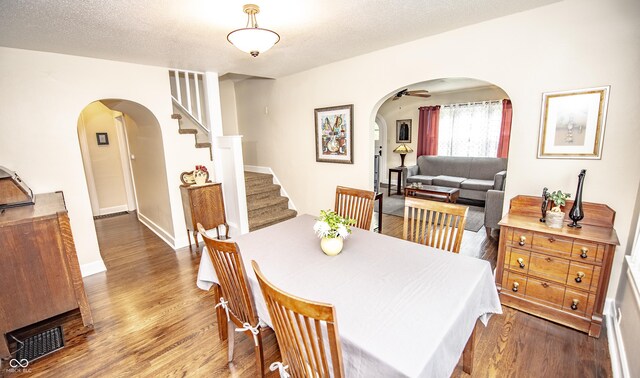 5024 N Kenwood Ave, Indianapolis, IN 46208 - dining room featuring arched walkways, wood finished floors, and stairs