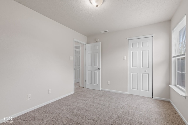 2270 Collins Way, Greenfield, IN 46140 - unfurnished bedroom featuring carpet, a textured ceiling, and a closet