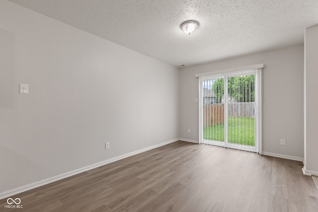 2270 Collins Way, Greenfield, IN 46140 - empty room featuring wood finished floors and a textured ceiling