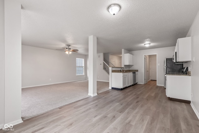 2270 Collins Way, Greenfield, IN 46140 - unfurnished living room featuring a textured ceiling, light wood finished floors, and ceiling fan