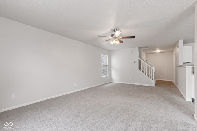 2270 Collins Way, Greenfield, IN 46140 - unfurnished living room featuring a ceiling fan, light carpet, stairs, and a textured ceiling