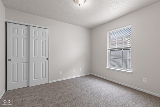 2270 Collins Way, Greenfield, IN 46140 - unfurnished bedroom featuring carpet, a textured ceiling, and a closet