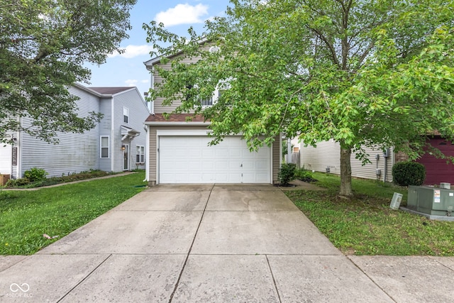 2270 Collins Way, Greenfield, IN 46140 - view of property hidden behind natural elements with driveway, a front lawn, and a garage
