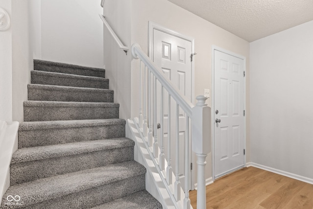 2270 Collins Way, Greenfield, IN 46140 - stairs featuring wood finished floors and a textured ceiling