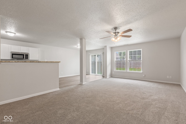 2270 Collins Way, Greenfield, IN 46140 - unfurnished living room with a textured ceiling, ceiling fan, and light carpet