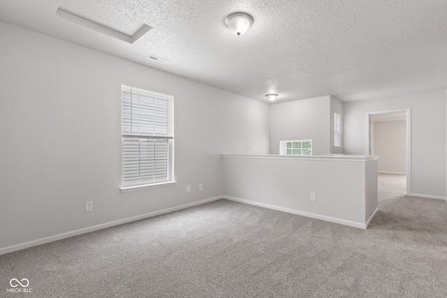 2270 Collins Way, Greenfield, IN 46140 - carpeted spare room with a textured ceiling, plenty of natural light, and attic access