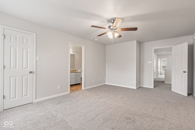 2270 Collins Way, Greenfield, IN 46140 - unfurnished bedroom with carpet floors, a textured ceiling, connected bathroom, and a ceiling fan
