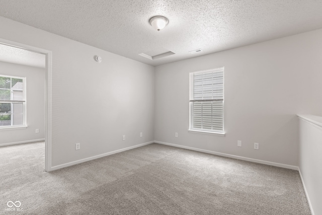 2270 Collins Way, Greenfield, IN 46140 - spare room featuring a textured ceiling, carpet flooring, attic access, and a smoke detector