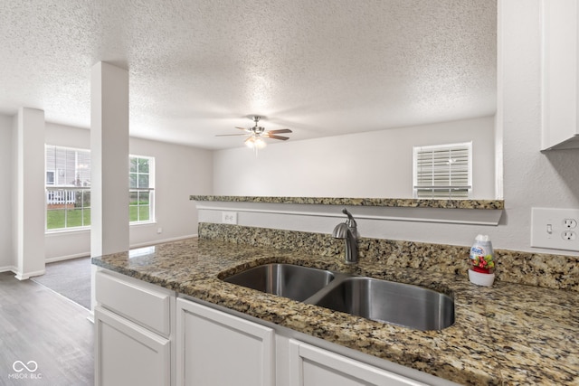 2270 Collins Way, Greenfield, IN 46140 - kitchen featuring white cabinetry, light wood finished floors, a ceiling fan, light stone counters, and a textured ceiling