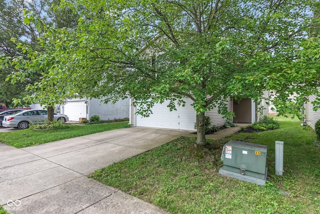 2270 Collins Way, Greenfield, IN 46140 - view of property hidden behind natural elements with concrete driveway, a front yard, and a garage