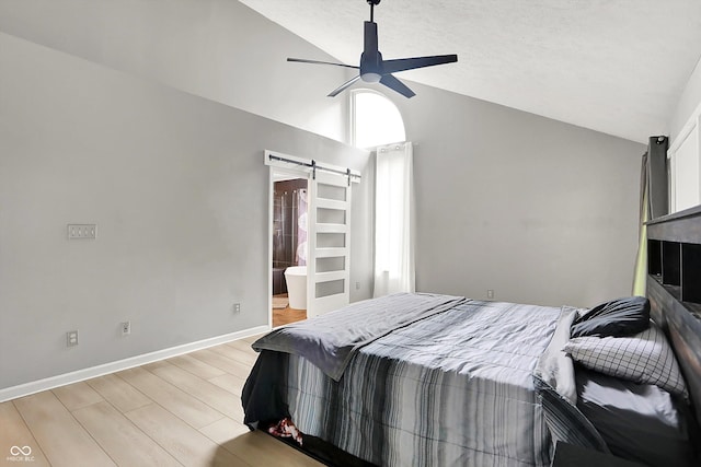 1264 Black Oak Dr, Greenwood, IN 46143 - bedroom featuring a barn door, light wood-style flooring, ceiling fan, high vaulted ceiling, and baseboards