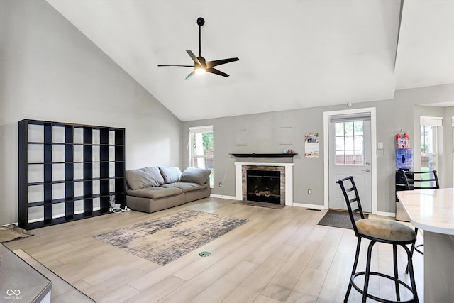 1264 Black Oak Dr, Greenwood, IN 46143 - living room with ceiling fan, high vaulted ceiling, light wood-style floors, a fireplace with flush hearth, and baseboards