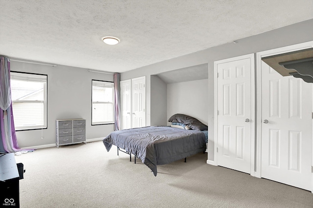 1264 Black Oak Dr, Greenwood, IN 46143 - bedroom featuring multiple closets, carpet floors, a textured ceiling, and baseboards