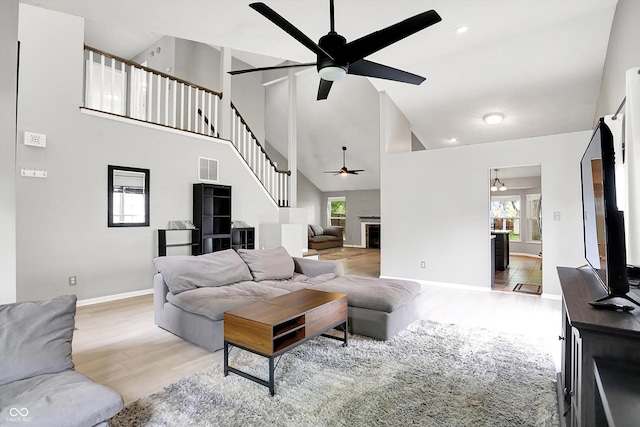 1264 Black Oak Dr, Greenwood, IN 46143 - living area with a ceiling fan, high vaulted ceiling, wood finished floors, healthy amount of natural light, and baseboards