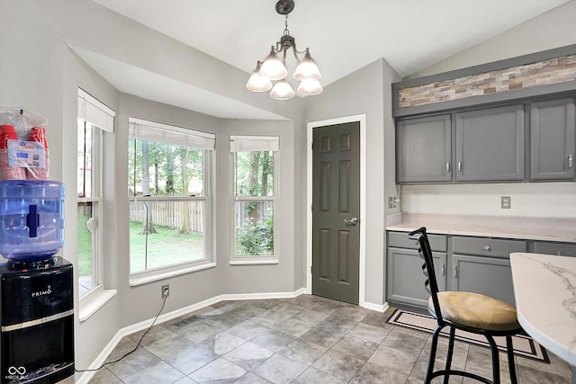 1264 Black Oak Dr, Greenwood, IN 46143 - dining space with vaulted ceiling, a chandelier, and baseboards