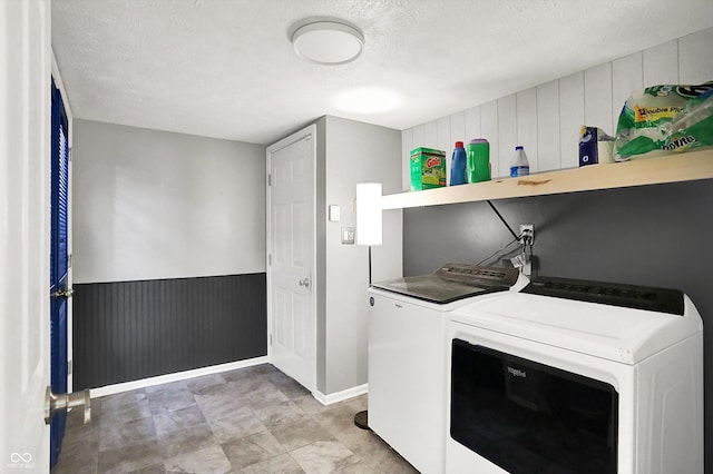 1264 Black Oak Dr, Greenwood, IN 46143 - laundry room featuring washing machine and dryer, baseboards, a textured ceiling, and wood walls