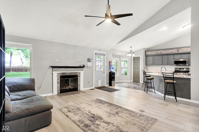 1264 Black Oak Dr, Greenwood, IN 46143 - living room with healthy amount of natural light, light wood-style floors, high vaulted ceiling, and a ceiling fan