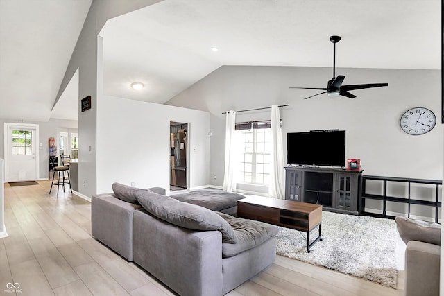 1264 Black Oak Dr, Greenwood, IN 46143 - living area with vaulted ceiling, plenty of natural light, ceiling fan, and light wood-type flooring