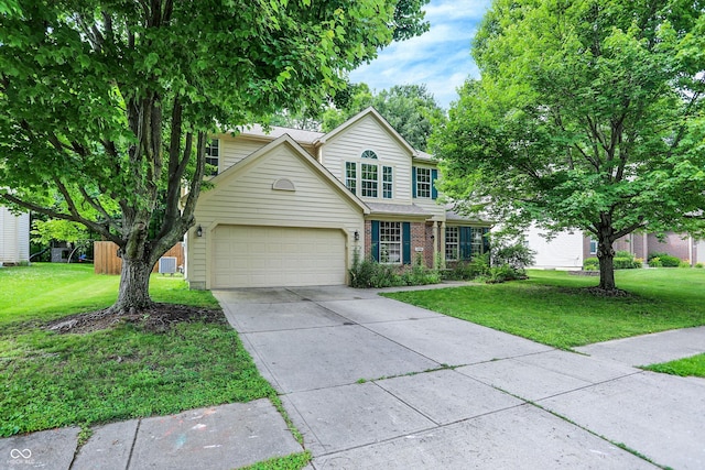 1264 Black Oak Dr, Greenwood, IN 46143 - traditional home with concrete driveway, a front yard, a garage, and brick siding