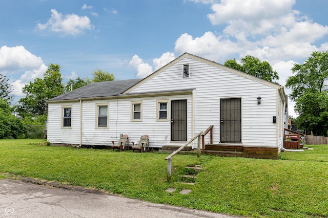 3065 N Colorado Ave, Indianapolis, IN 46218 - view of front of home featuring a front lawn, entry steps, and roof with shingles
