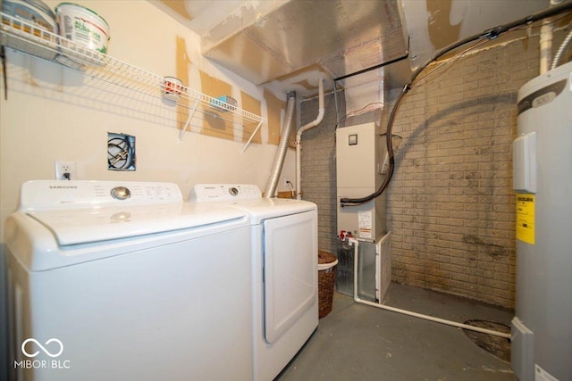 8410 Hague Rd Unit 5, Indianapolis, IN 46256 - laundry area with electric water heater, washer and dryer, and brick wall