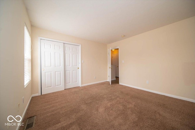 8410 Hague Rd Unit 5, Indianapolis, IN 46256 - unfurnished bedroom with carpet flooring, multiple windows, and a closet